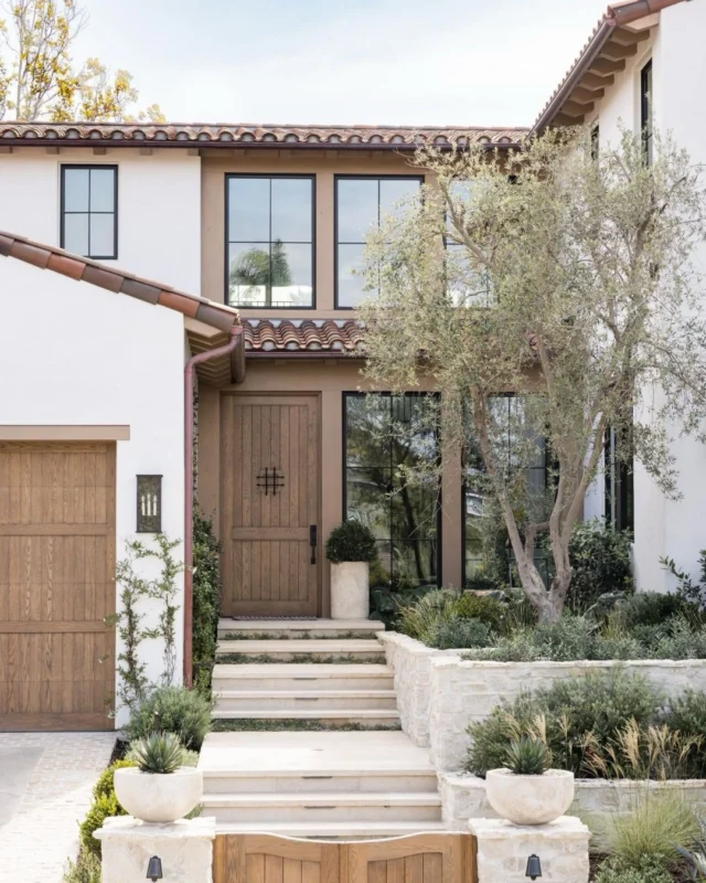 A first impression rooted in warmth and timeless character. For the front exterior at #mgdxpaseoclemente, we let natural materials lead the way, layering in wood moments for softness, and grounding everything with subtle contrast. A home that nods to San Clemente’s Spanish roots, while still feeling clean, classic, and modern. See more on Substack! 🤍 #mindygayerdesign { Image by: @vlentine, Architect: @brandonarchitects, Builder: @sayerandsons, Landscape Design: @chelseacorinnestudio }