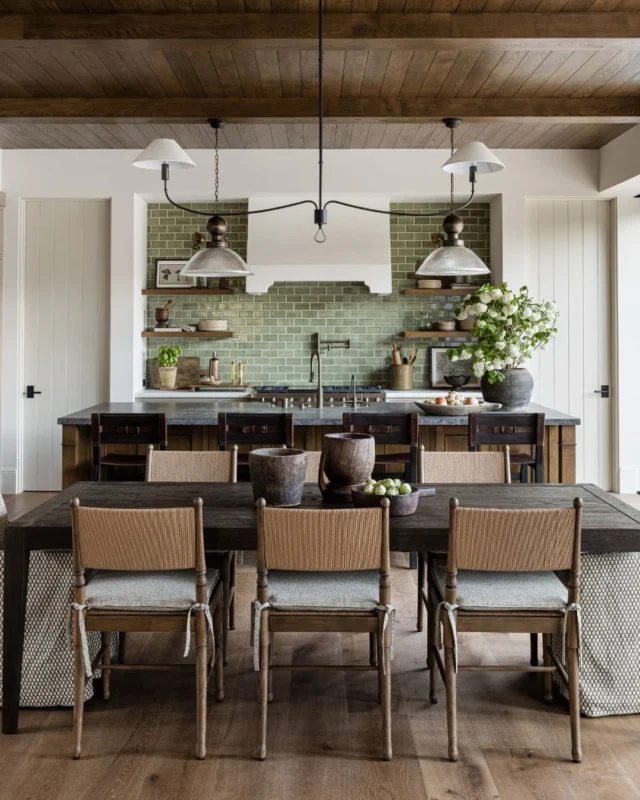At the center of it all ✨️ The dining room at #mgdxpaseoclemente bridges the space between the great room and the kitchen. Woven chairs bring warmth, custom cushions soften the silhouette, and a tailored built-in with ample cabinetry offers thoughtful overflow storage. Up next: the kitchen. 🤍 #mindygayerdesign { Image by: @vlentine, Architect: @brandonarchitects, Builder: @sayerandsons }